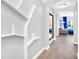 Bright hallway with built-in shelving and wood floors at 14501 Grove Resort Ave # 1430, Winter Garden, FL 34787