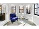 Bright sitting area with a comfortable armchair and large windows at 14501 Grove Resort Ave # 1430, Winter Garden, FL 34787