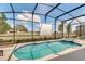 Screened pool and spa with projector for outdoor entertainment at 5288 Oakbourne Ave, Davenport, FL 33837