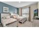 Two twin beds, calming decor, and large window in this serene bedroom at 5288 Oakbourne Ave, Davenport, FL 33837