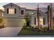 Two story home with neutral exterior and landscaping at 5288 Oakbourne Ave, Davenport, FL 33837