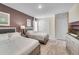 Two twin beds, TV, and ample closet space in this well-appointed bedroom at 5288 Oakbourne Ave, Davenport, FL 33837