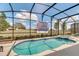 Screened pool and spa with projector for outdoor entertainment at 5288 Oakbourne Ave, Davenport, FL 33837