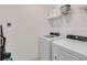 Convenient laundry room with washer, dryer, and ample shelving at 5288 Oakbourne Ave, Davenport, FL 33837