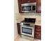 Modern kitchen featuring stainless steel appliances and dark wood cabinets at 910 Lake Ave, Edgewater, FL 32132