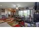 Combined dining and living area, dark wood table, leather couches, area rug at 3115 Albert St, Orlando, FL 32806