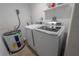 Laundry room with washer, dryer, and hot water heater at 2627 Ambergate Rd, Winter Park, FL 32792