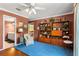 Bright bonus room with built-in shelving and ensuite bathroom at 10980 Jim Edwards Rd, Haines City, FL 33844