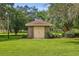 Small brick storage shed in grassy backyard setting at 10980 Jim Edwards Rd, Haines City, FL 33844