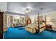Spacious main bedroom with a seating area and blue carpet at 10980 Jim Edwards Rd, Haines City, FL 33844