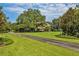 Long driveway leading to a stunning home with mature trees at 10980 Jim Edwards Rd, Haines City, FL 33844