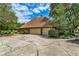 Three-car garage with large concrete driveway at 10980 Jim Edwards Rd, Haines City, FL 33844