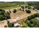 Aerial view of pasture area with outbuildings at 10980 Jim Edwards Rd, Haines City, FL 33844