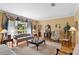 Living room with hardwood floors, striped sofa, and ample natural light at 10980 Jim Edwards Rd, Haines City, FL 33844