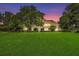 Stunning two-story home with manicured lawn and mature trees at 10980 Jim Edwards Rd, Haines City, FL 33844
