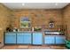 Outdoor kitchen with blue cabinets, grill, and sink at 10980 Jim Edwards Rd, Haines City, FL 33844
