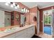 Double vanity bathroom with pink countertops and updated fixtures at 10980 Jim Edwards Rd, Haines City, FL 33844