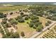 Aerial view showing the house and surrounding farmlands at 10980 Jim Edwards Rd, Haines City, FL 33844
