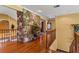 Hardwood floors and a stone accent wall in the upper hallway at 10980 Jim Edwards Rd, Haines City, FL 33844
