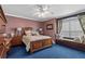 Bedroom with a queen bed, window seat and blue carpet at 10980 Jim Edwards Rd, Haines City, FL 33844