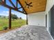 Relaxing covered patio with paver stones and wood beam accents at 544 Waterfern Trail Dr, Auburndale, FL 33823