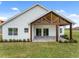 Home exterior showcasing a covered patio and landscaping at 544 Waterfern Trail Dr, Auburndale, FL 33823