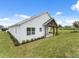 Side view of the house with covered patio and landscaping at 544 Waterfern Trail Dr, Auburndale, FL 33823