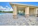 Covered patio area with tables and chairs near the pool at 1277 Tagliamento Ln, Haines City, FL 33844