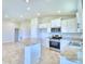 Open kitchen with island and stainless steel appliances at 1277 Tagliamento Ln, Haines City, FL 33844