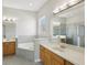 Bathroom with double sinks, corner bathtub, and shower at 1554 Fairview Cir, Kissimmee, FL 34747