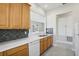 View of kitchen with wood cabinets and dishwasher at 1554 Fairview Cir, Kissimmee, FL 34747