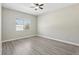 Simple bedroom with light gray walls and wood-look flooring at 1554 Fairview Cir, Kissimmee, FL 34747