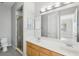 Double vanity bathroom with light wood cabinets, a shower, and tile flooring at 1554 Fairview Cir, Kissimmee, FL 34747