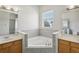 Bathroom with double sinks, corner bathtub, and shower at 1554 Fairview Cir, Kissimmee, FL 34747