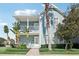 Two-story house with a light blue exterior, front porch, and lush landscaping at 1554 Fairview Cir, Kissimmee, FL 34747