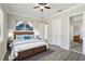 Main bedroom with wood flooring, ceiling fan, and ensuite bathroom access at 1554 Fairview Cir, Kissimmee, FL 34747