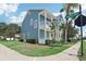 Two-story light blue house with balcony and landscaping at 1554 Fairview Cir, Kissimmee, FL 34747