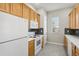 White appliances and light wood cabinets in this kitchen at 1554 Fairview Cir, Kissimmee, FL 34747