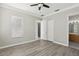 Spacious bedroom with light grey walls, wood-look flooring, and a ceiling fan at 1554 Fairview Cir, Kissimmee, FL 34747