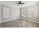 Well-lit bedroom featuring wood-look flooring and three windows with blinds at 1554 Fairview Cir, Kissimmee, FL 34747