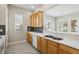 Kitchen features light wood cabinets and stainless steel appliances at 1554 Fairview Cir, Kissimmee, FL 34747