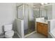 Bathroom with shower, toilet and wooden vanity at 1554 Fairview Cir, Kissimmee, FL 34747