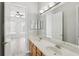 Bright bathroom with double sinks and a view of a bedroom at 1554 Fairview Cir, Kissimmee, FL 34747