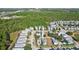 Aerial view of neighborhood with houses and pond at 1554 Fairview Cir, Kissimmee, FL 34747