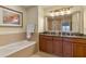 Bathroom with double vanity, soaking tub, and walk-in shower at 1106 Sunset View Cir # 201, Reunion, FL 34747