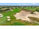 Aerial view of a lush green golf course with sand traps at 1106 Sunset View Cir # 201, Reunion, FL 34747