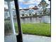 View of a canal and neighboring townhouses from a patio at 2512 Woodgate Blvd # 104, Orlando, FL 32822