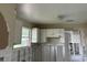 A kitchen undergoing renovation, showing exposed walls and framing at 2512 Woodgate Blvd # 104, Orlando, FL 32822