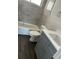 Modern bathroom with gray vanity and a bathtub at 2512 Woodgate Blvd # 104, Orlando, FL 32822