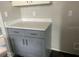 Gray kitchen cabinets with white countertops at 2512 Woodgate Blvd # 104, Orlando, FL 32822